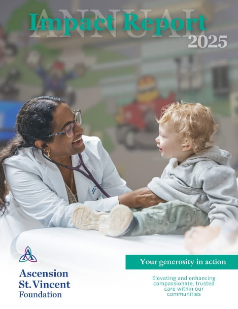 Cover of a Ascension St. Vincent Foundation 2025 annual report featuring a healthcare professional in a white coat speaking with an child patient seated in a clinical setting. 